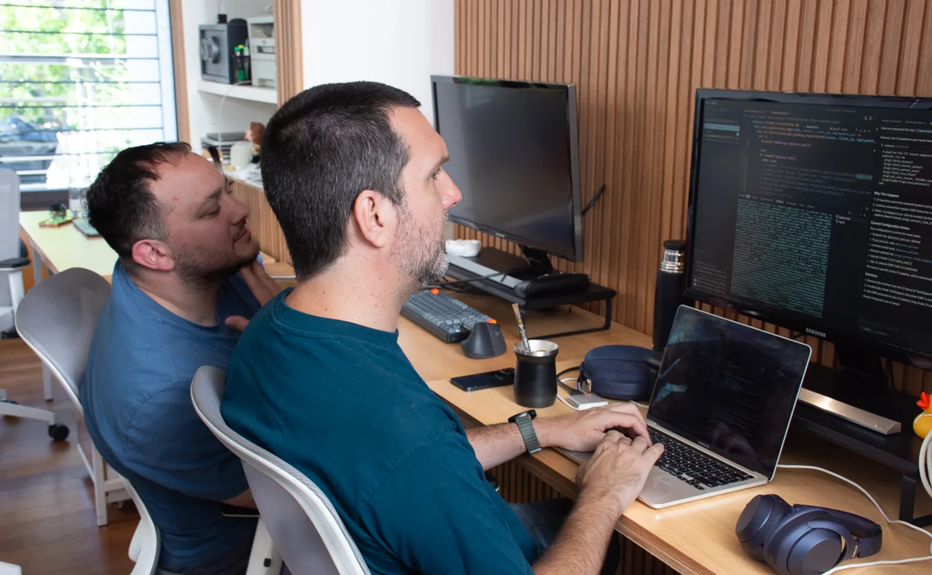 Developer working at a desk with multiple screens showing code