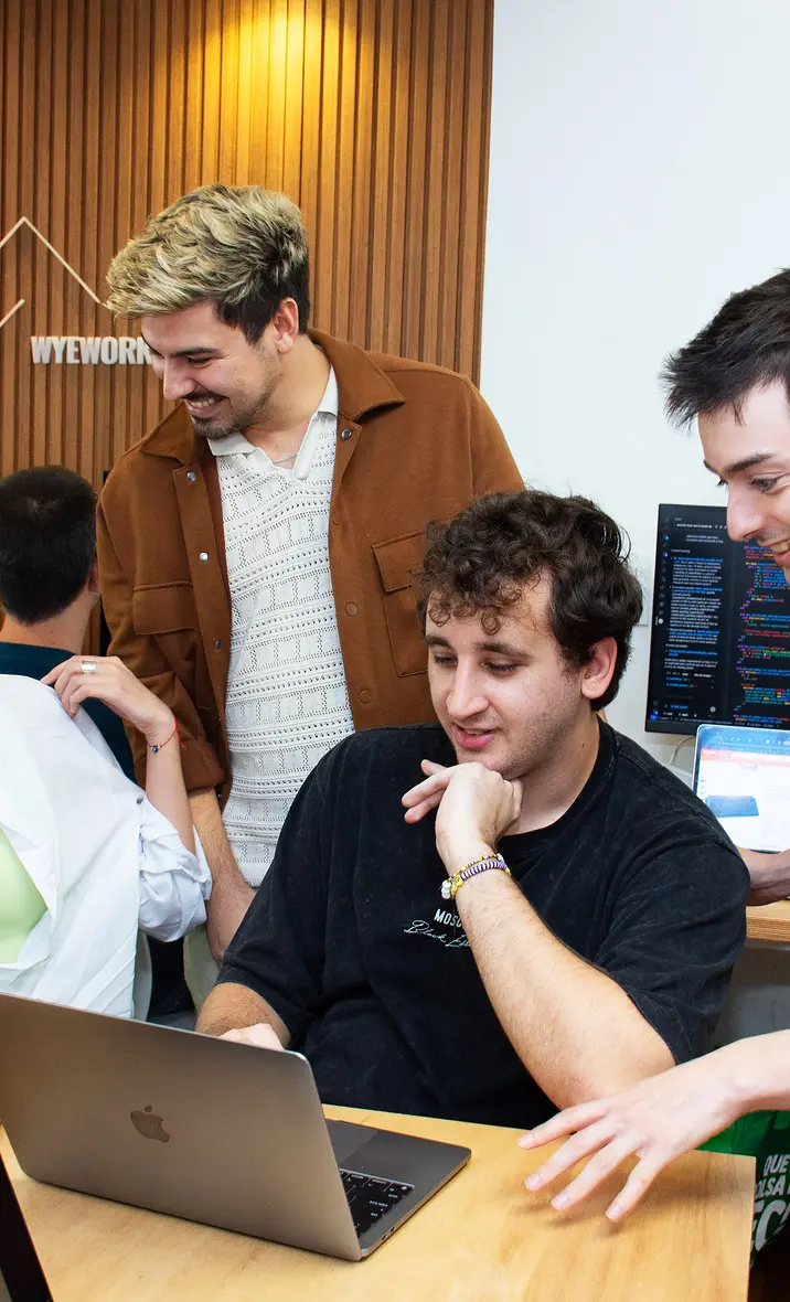 Developer working at a desk with code on multiple screens